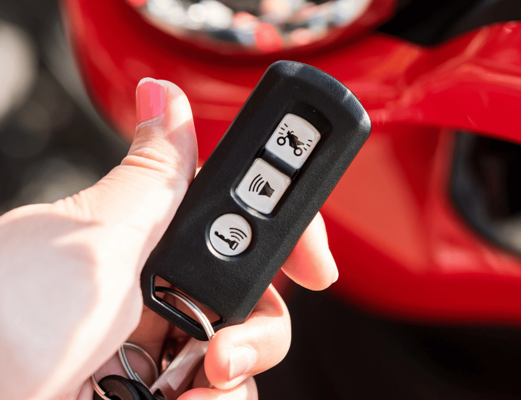 Technician programming a car key at a vehicle